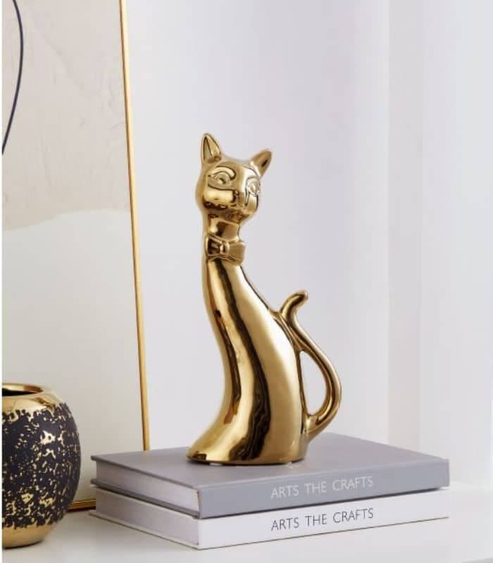 Objet décoratif à pose chat stylisé en céramique or 25x8x12 cm